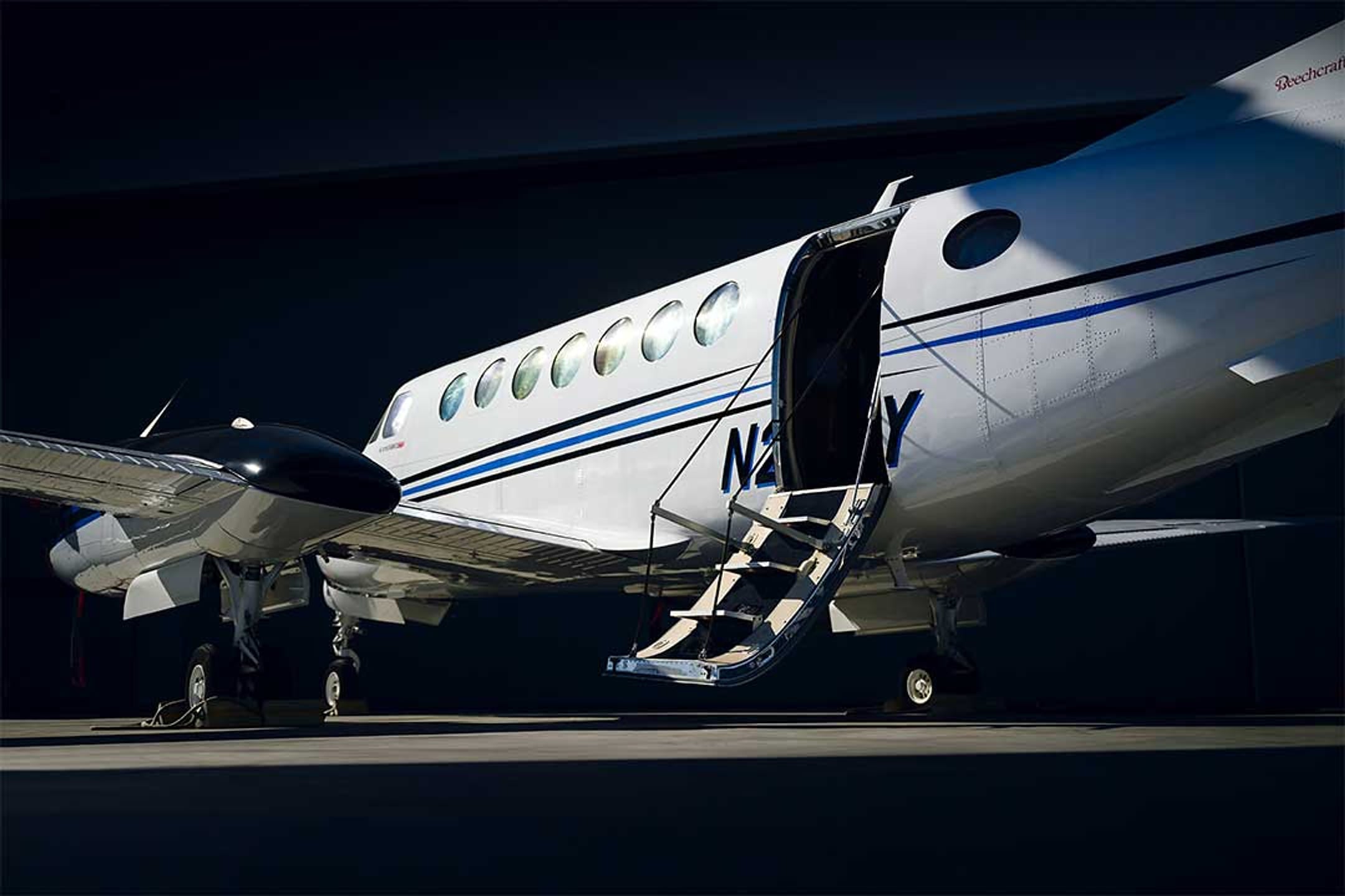 The airstair door of a King Air 350 open on the ramp