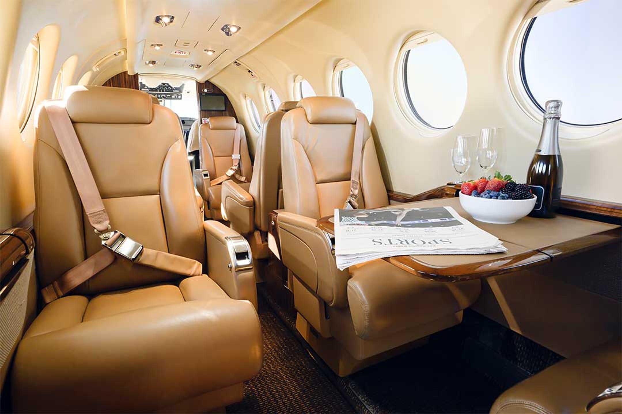 King Air 350 cabin with facing leather club seats and a folding table
