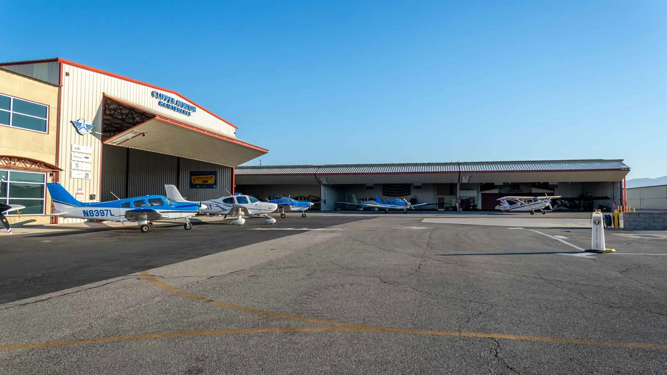 Training aircraft parked outside the Clipper Aviation maintenance hangar
