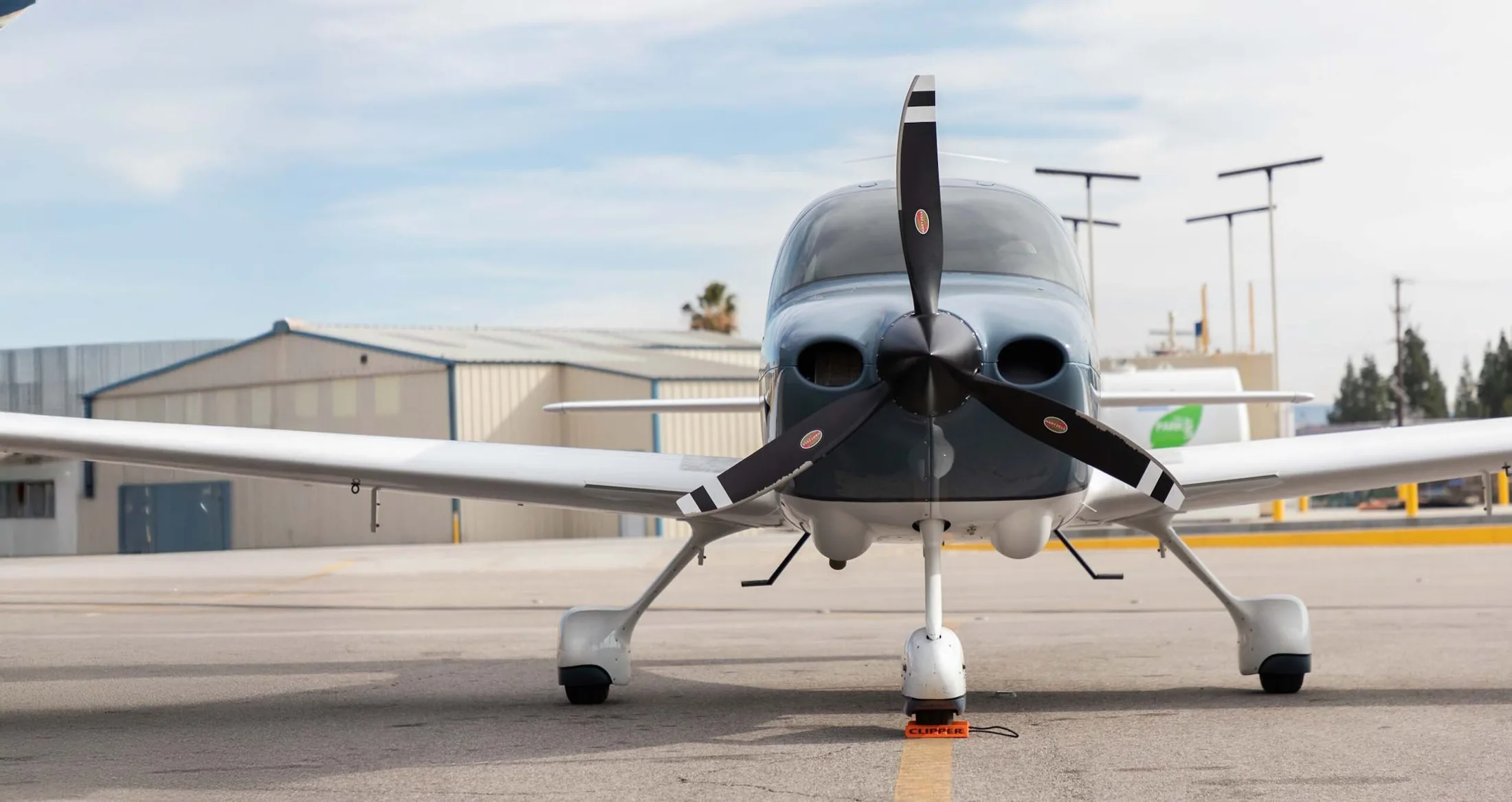 A Cirrus training aircraft chocked on the Clipper Aviation ramp