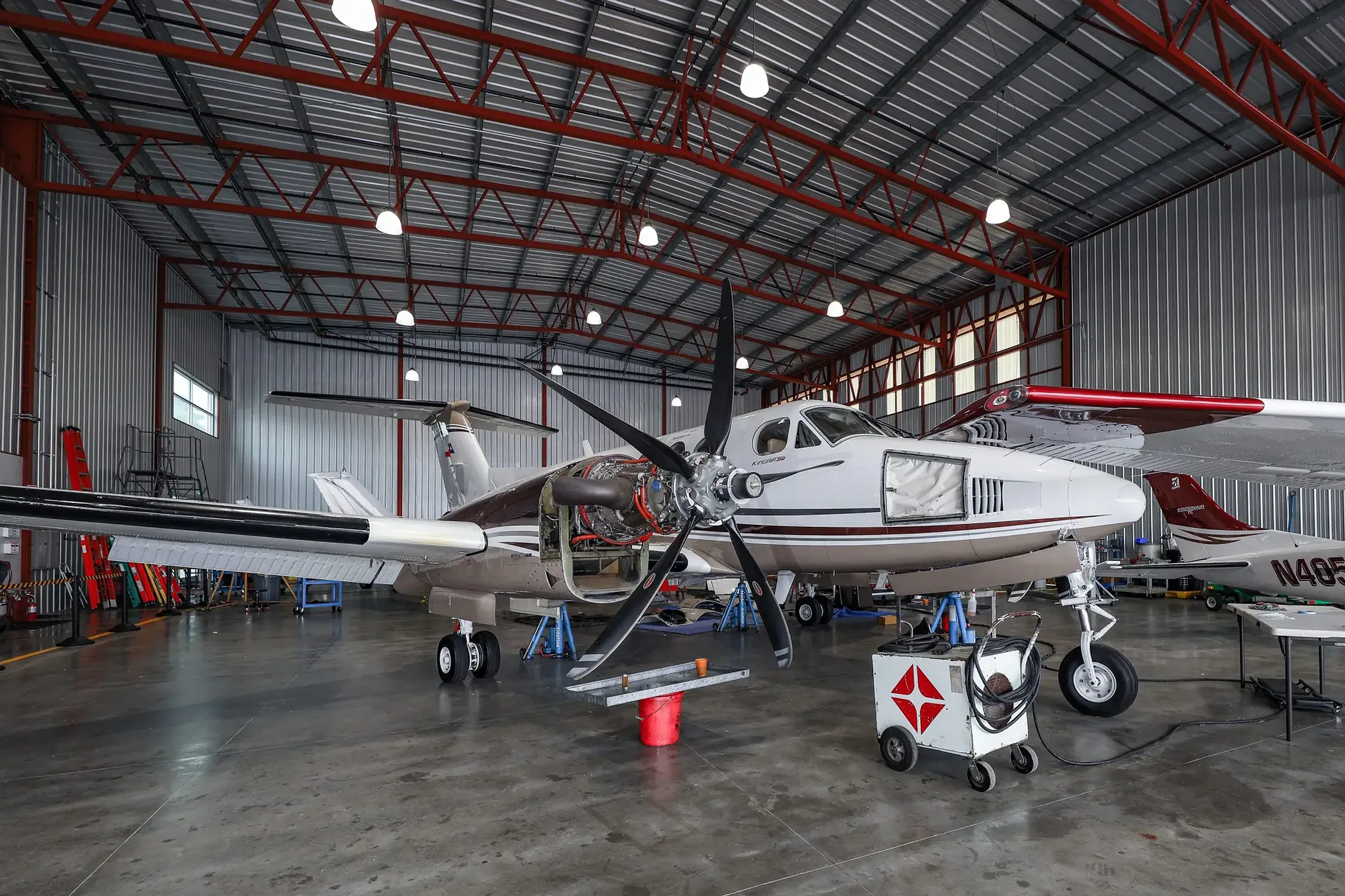 A King Air 350 in the Clipper Aviation hangar with an engine opened for inspection